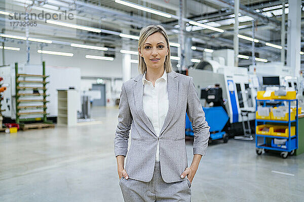 Portrait of confident businesswoman in factory