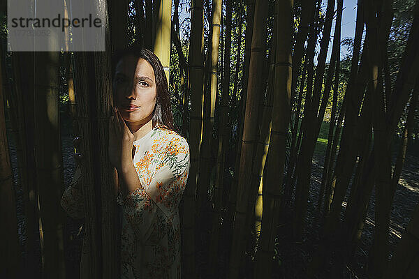 Woman standing in bamboo grove