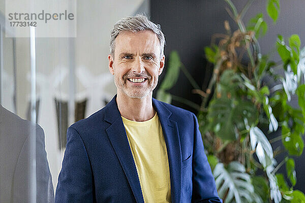 Portrait of smiling mature businessman in office