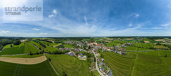 Germany  Bavaria  Kammeltal  Helicopter panorama of rural town surrounded by green fields in summer