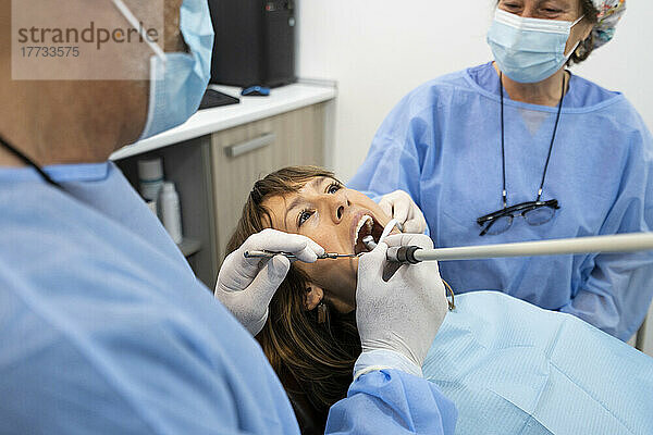 Dentists examining patient at clinic