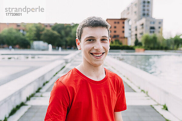 Happy teenage boy wearing red t-shirt