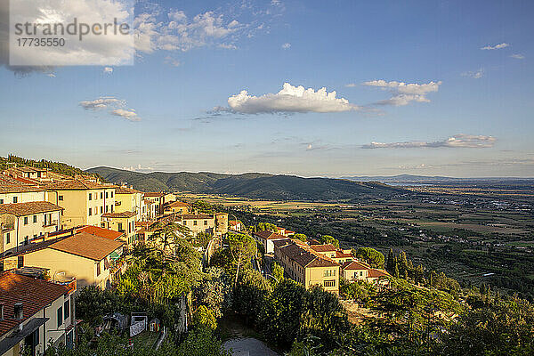 Italy  Province of Arezzo  Cortona  View of town overlooking Chiana Valley at summer dusk