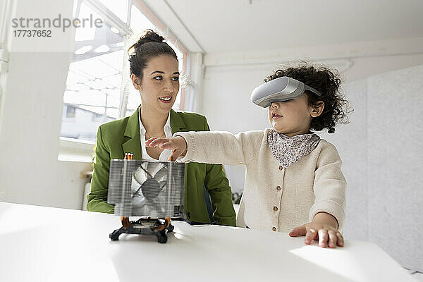 Mutter und Tochter erkunden die High-Tech-Entwicklung des Metaversums mithilfe eines Virtual-Reality-Simulators