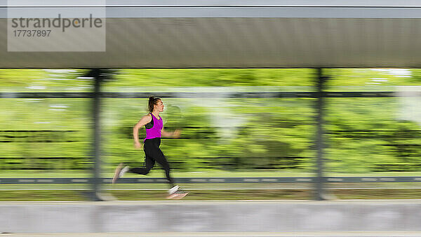 Young athlete running in sports park