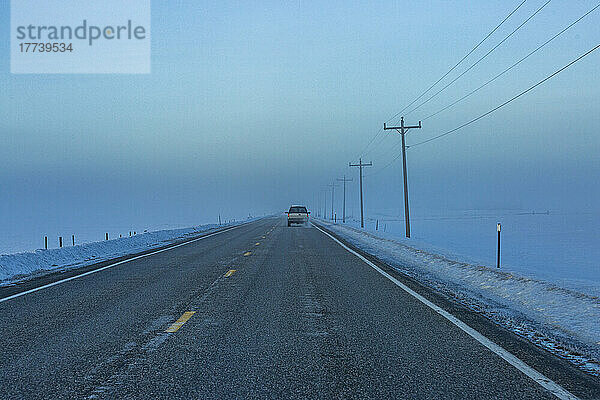 USA  Idaho  Fairfield  Auto fährt im Winter entlang des Highway 20 in die Nebelbank