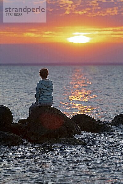 Frau sitzt auf Steinen  Sonnenuntergang  Steinbeck  Klütz  Mecklenburg-Vorpommern  Deutschland  Europa