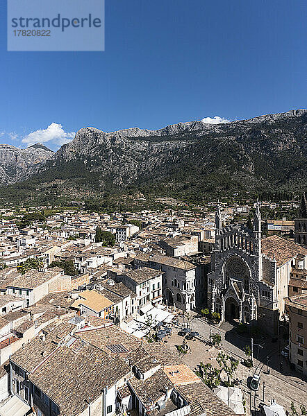 Spanien  Balearen  Soller  Hubschrauberansicht der Kirche St. Bartholomäus und der umliegenden Häuser mit dem Serra de Tramuntana-Gebirge im Hintergrund