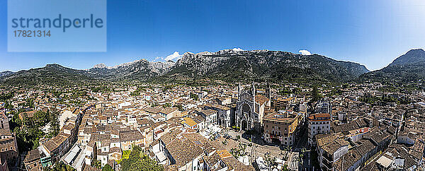 Spain  Balearic Islands  Soller  Helicopter panorama of Church of Saint Bartholomew and surrounding houses with Serra de Tramuntana mountains in background