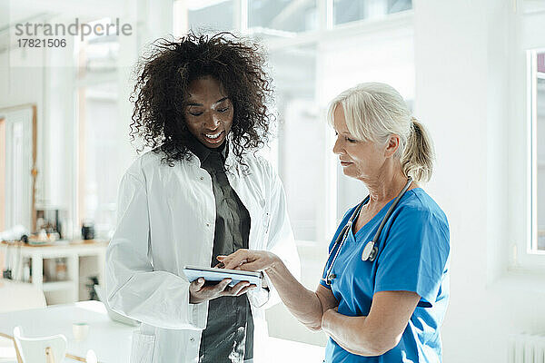 Two female doctors sharing tablet PC