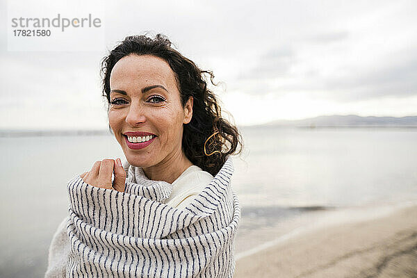 Smiling woman wrapped in scarf