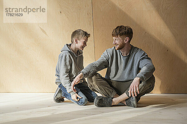 Father and son spending time together at wooden house