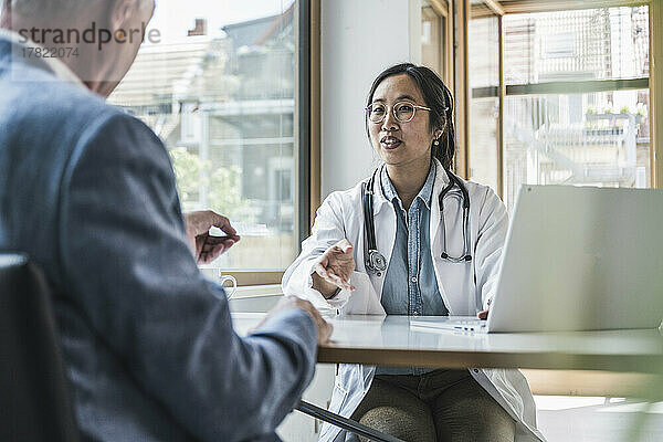 Doctor discussing with patient at medical clinic