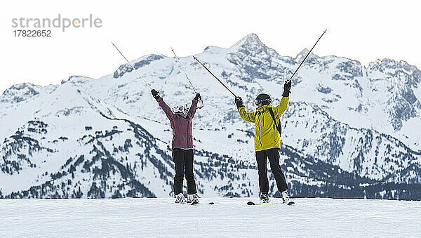 Paar mit Skistöcken vor schneebedecktem Berg  Baqueira Beret  Pyrenäen  Spanien