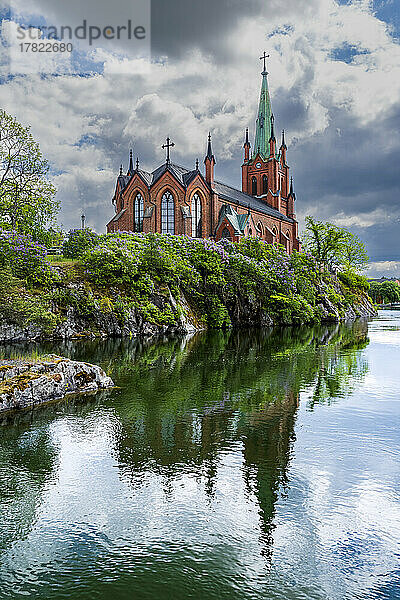 Sweden  Vastra Gotaland County  Trollhattan  Clouds over bank of Gota Alv river and Trollhattans Kyrka