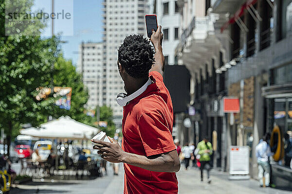 Mann macht Selfie mit Smartphone in der Stadt