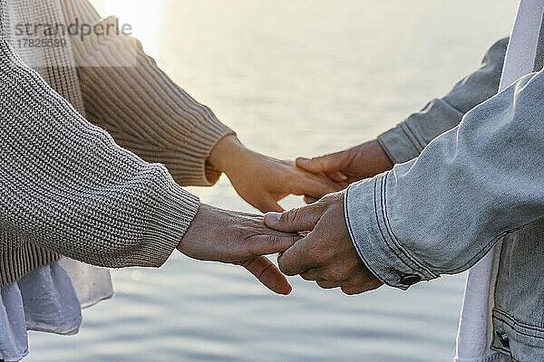 Man holding girlfriend's hands at beach