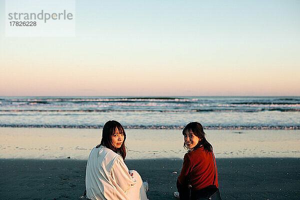 Young Japanese women enjoying themselves at the beach