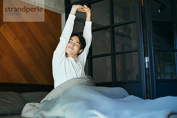 Japanese man in bed in the morning
