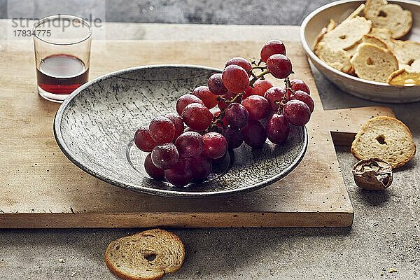 Stillleben mit roten Weintrauben  Walnüssen  Brotchips und Rotwein