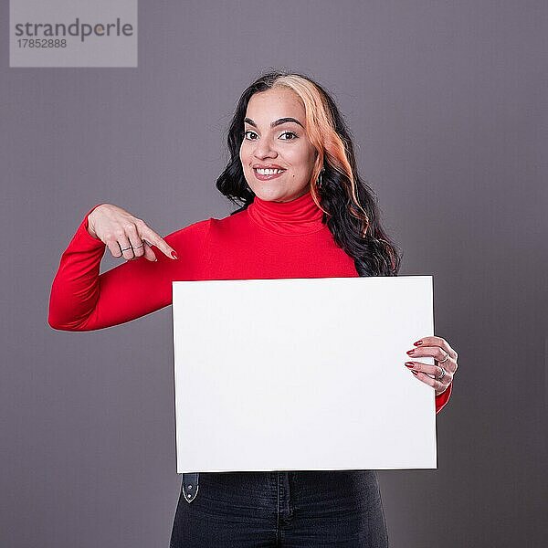 Schöne Frau  die auf ein leeres Whiteboard zeigt