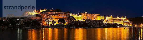 Romantischer Luxus-Indien-Reisetourismus  Stadtpalast-Komplex am Pichola-See in der Dämmerung  Udaipur  Rajasthan  Indien  Asien