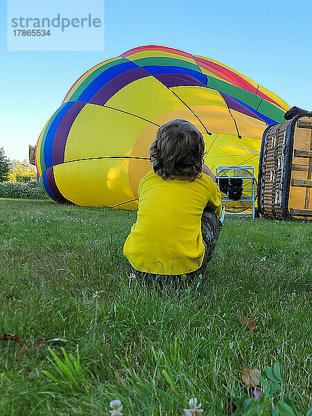 Kind schaut  wie ein Heißluftballon vorbereitet wird