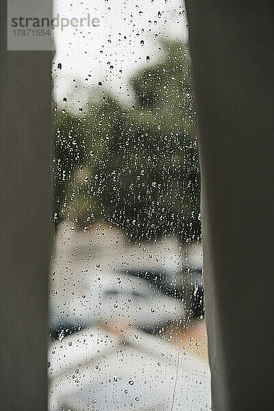 Curtains by window on rainy day at home
