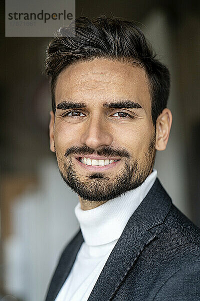 Smiling handsome young businessman wearing turtleneck