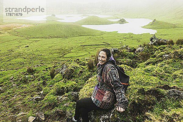 Young woman enjoying at volcanic crater Corvo  Azores  Portugal