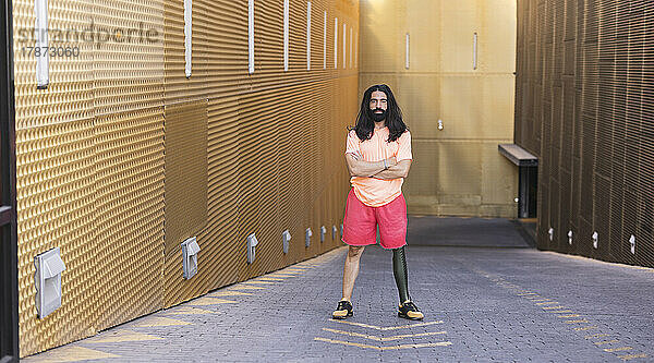 Bärtiger Mann mit Beinprothese steht auf der Straße
