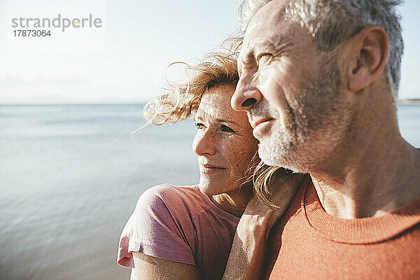 Mature man and woman spending time on vacation at beach