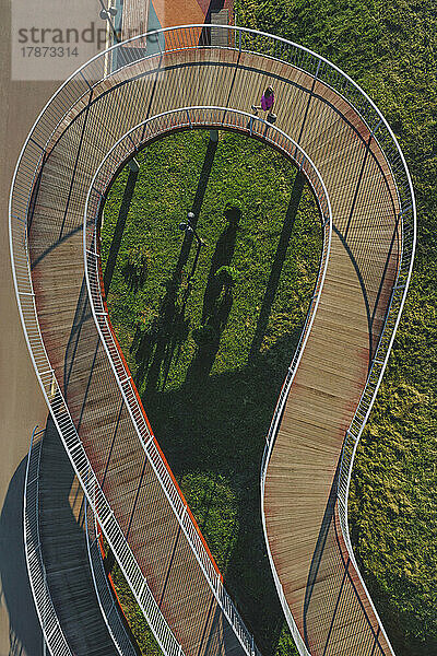 Russia  Aerial view of woman walking along winding boardwalk
