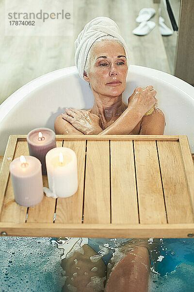 Mature woman taking bath in bathroom