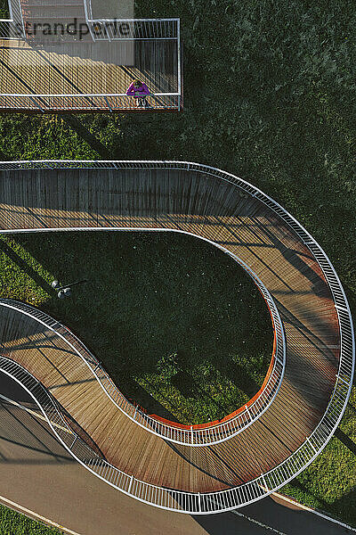 Russia  Aerial view of woman standing on winding boardwalk