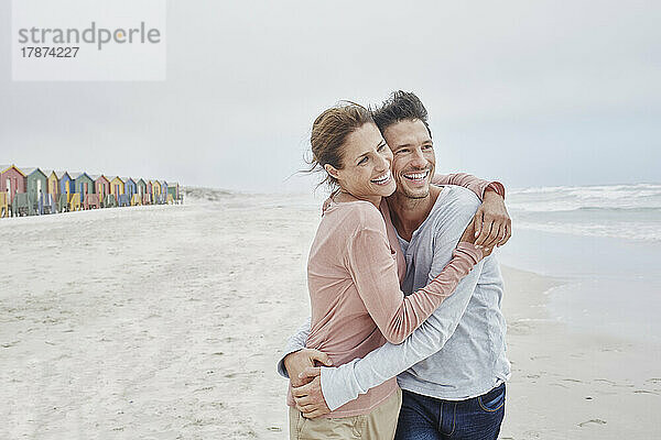 Zärtliches Paar umarmt sich am Strand