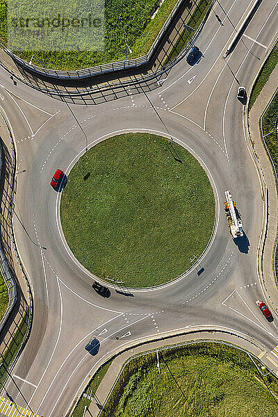 Vehicles at roundabout on sunny day