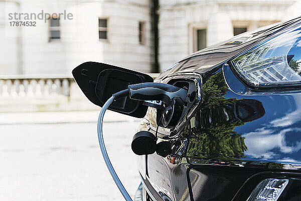 Ladekabel im Elektroauto am Straßenrand eingesteckt