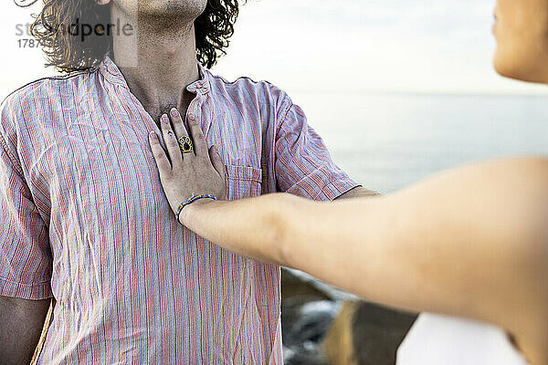 Girlfriend keeping hand on boyfriend's chest