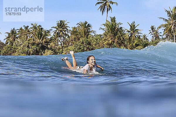 Glückliche Frau  die das Surfen auf dem Meer genießt
