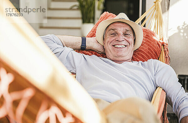 Happy man relaxing in hammock