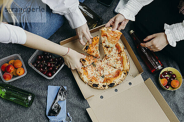 Junge Freunde  die zusammen Pizza essen