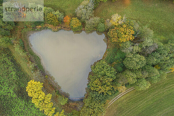 Drone view of small heart-shaped lake in Franconian Heights