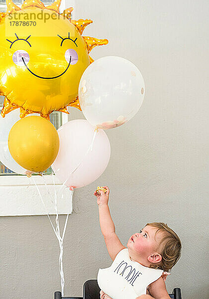 Babymädchen (12-17 Monate) mit Luftballons