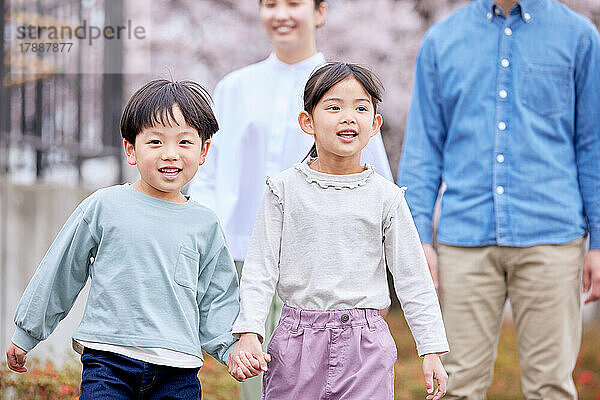 Japanische Familie mit blühenden Kirschblüten