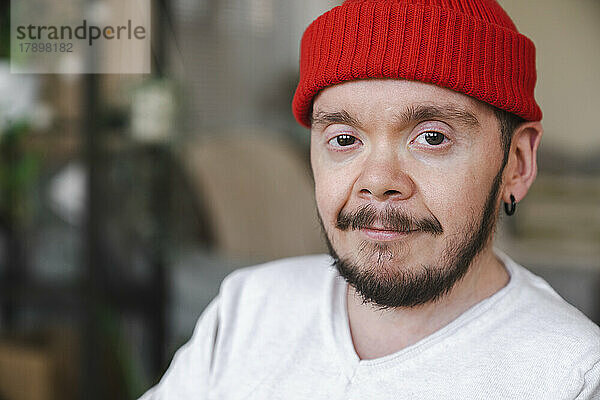 Confident man wearing red knit hat