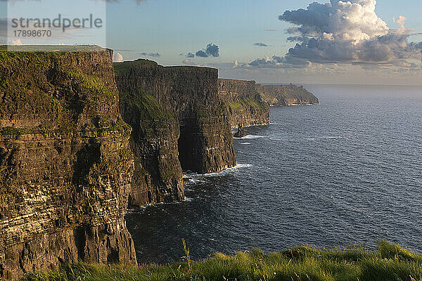 Idyllic Cliffs of Moher by sea at sunset  Ireland