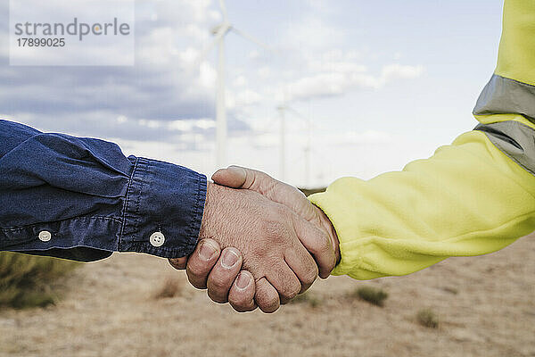 Ingenieur und Techniker beim Handschlag im Windpark