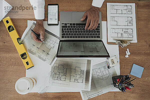 Hands of architect working at desk