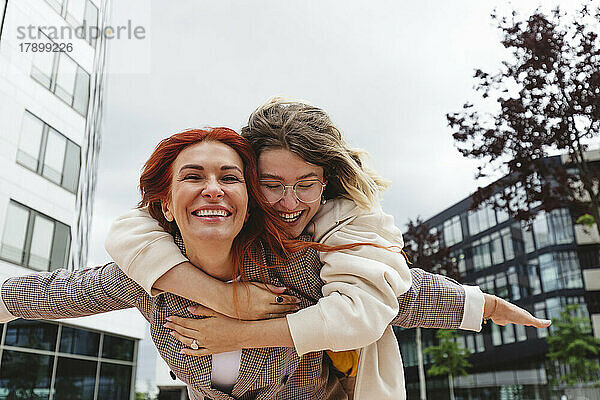 Cheerful woman hugging mother at Hafencity